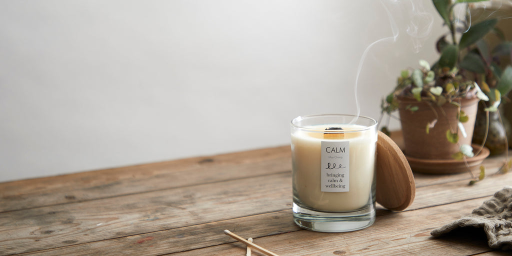 soy candle with wooden wick that had been blown out leaving a smoke ring