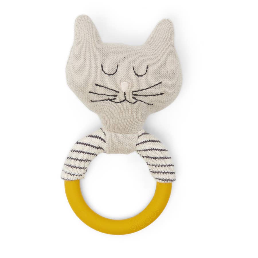 Knitted cat-shaped rattle with a yellow ring on a white background