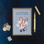 sister paper co. - happy birthday you silly goose illustrated card with kraft envelope on dark navy cloth background with a gold pen - winter's moon