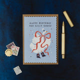 sister paper co. - happy birthday you silly goose illustrated card with kraft envelope on dark navy cloth background with a gold pen - winter's moon