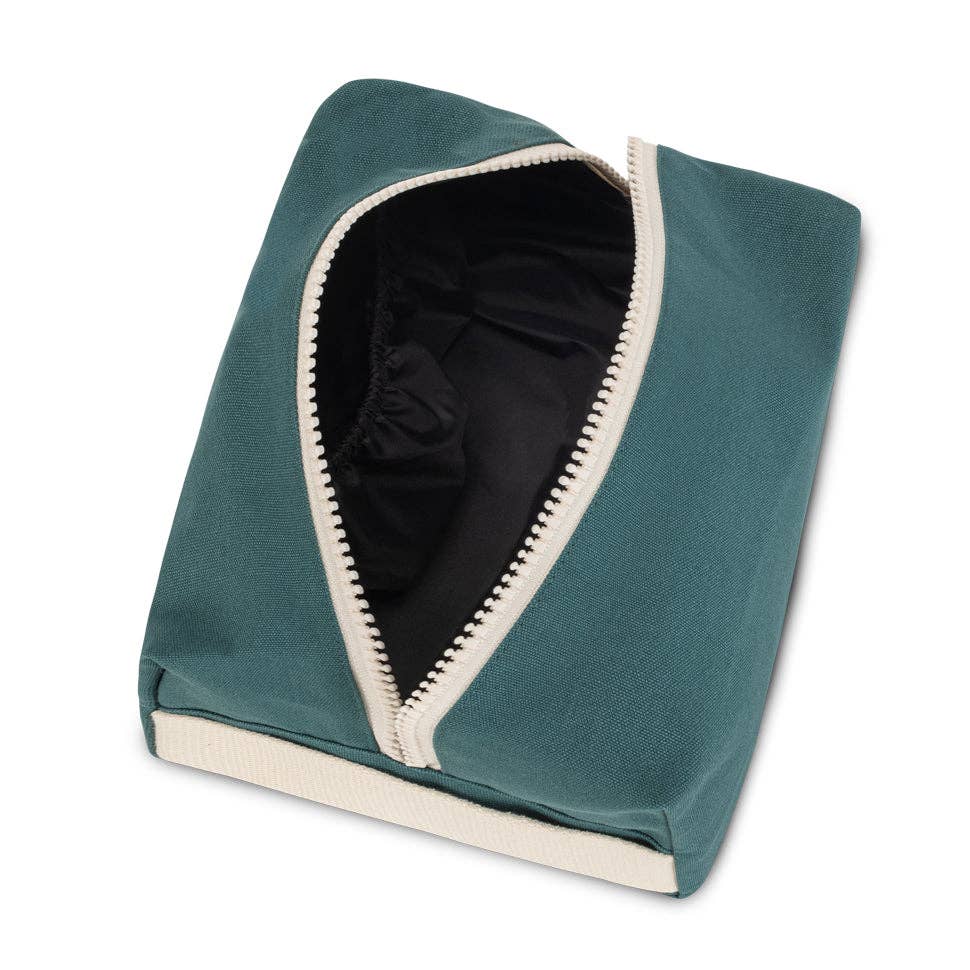 Teal pet bed with white trim on a white background