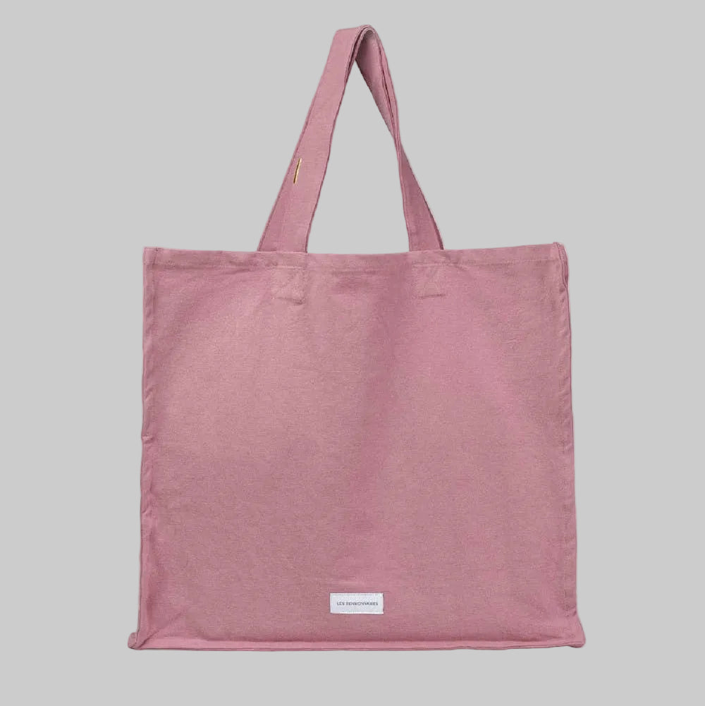 Pink tote bag with a stitched logo that reads 'Les Pensionnaires'