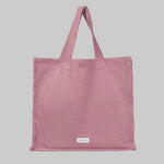 Pink tote bag with a stitched logo that reads 'Les Pensionnaires'