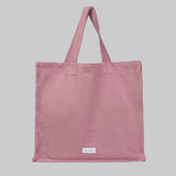 Pink tote bag with a stitched logo that reads 'Les Pensionnaires'