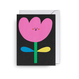 A  black mini card with a colour-block flower illustration by Susie Hammer. 