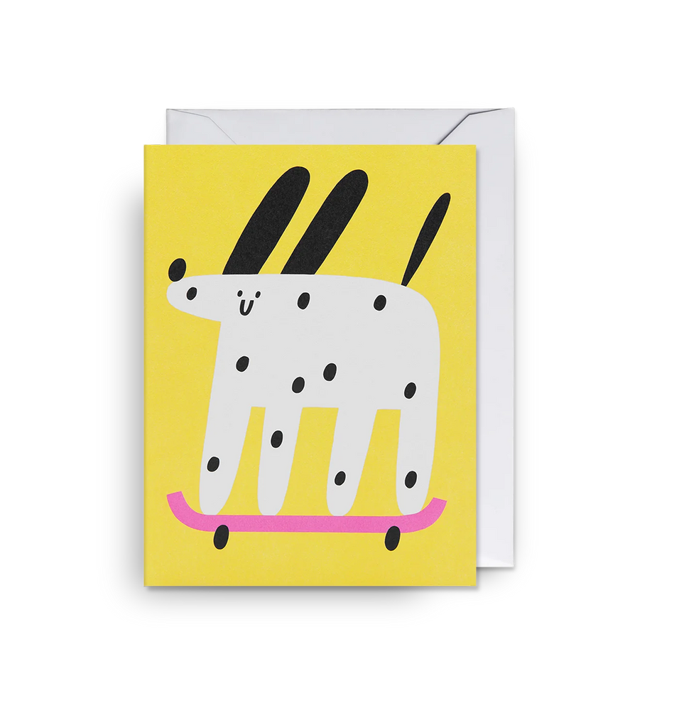 A yellow mini card by artist Susie Hammer, featuring a dog on a skateboard in graphic colours.