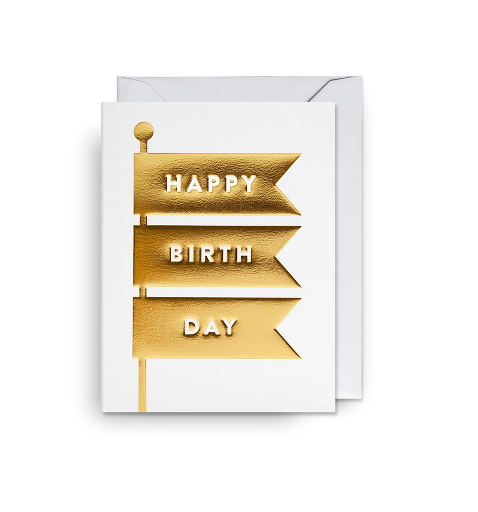 A white mini card with a gold foil embossed flag, with the message 'Happy birthday'. By Lagom Design.