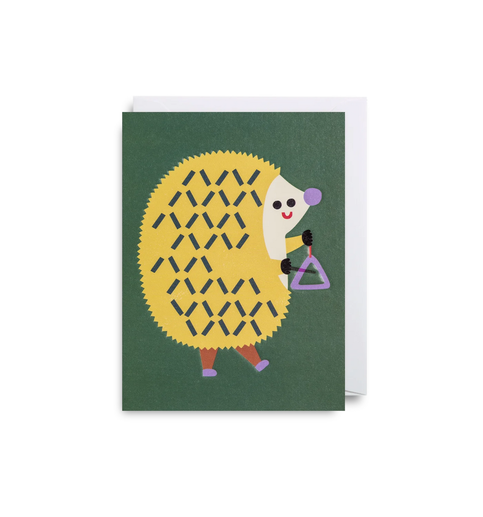 A green mini card from Lagom Design with an illustration of a hedgehog playing a triangle.