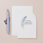 sister paper co - deepest sympathy feather card with envelope on pale background with fountain pen- winter's moon