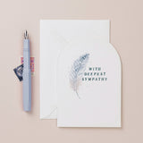 sister paper co - deepest sympathy feather card with envelope on pale background with fountain pen- winter's moon