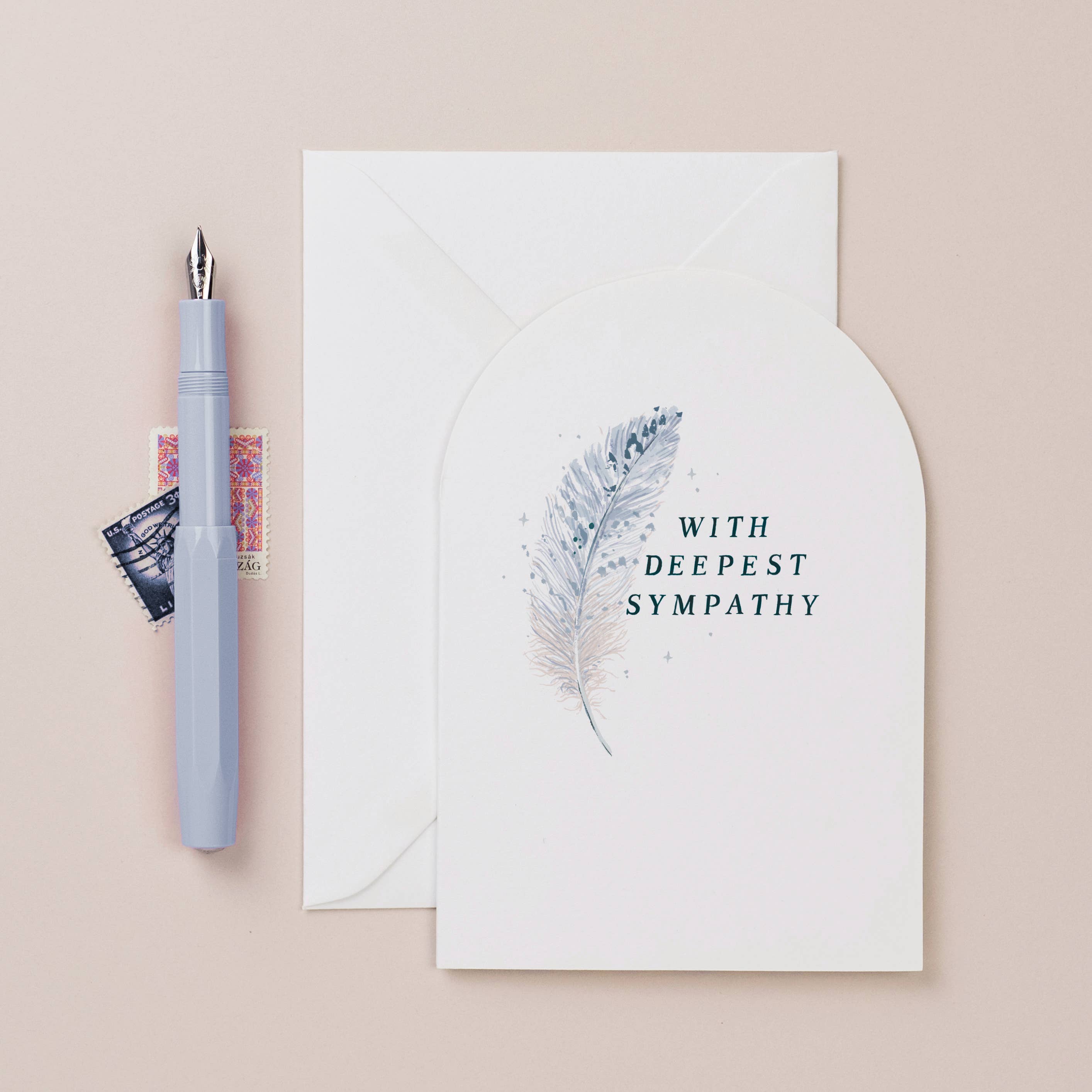 sister paper co - deepest sympathy feather card with envelope on pale background with fountain pen- winter's moon