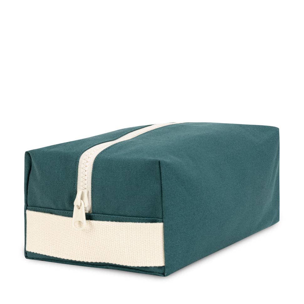 Teal toiletry bag with a white zipper on a white background