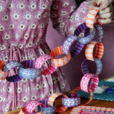 cambridge imprint - woman making paper chains - winter's moon