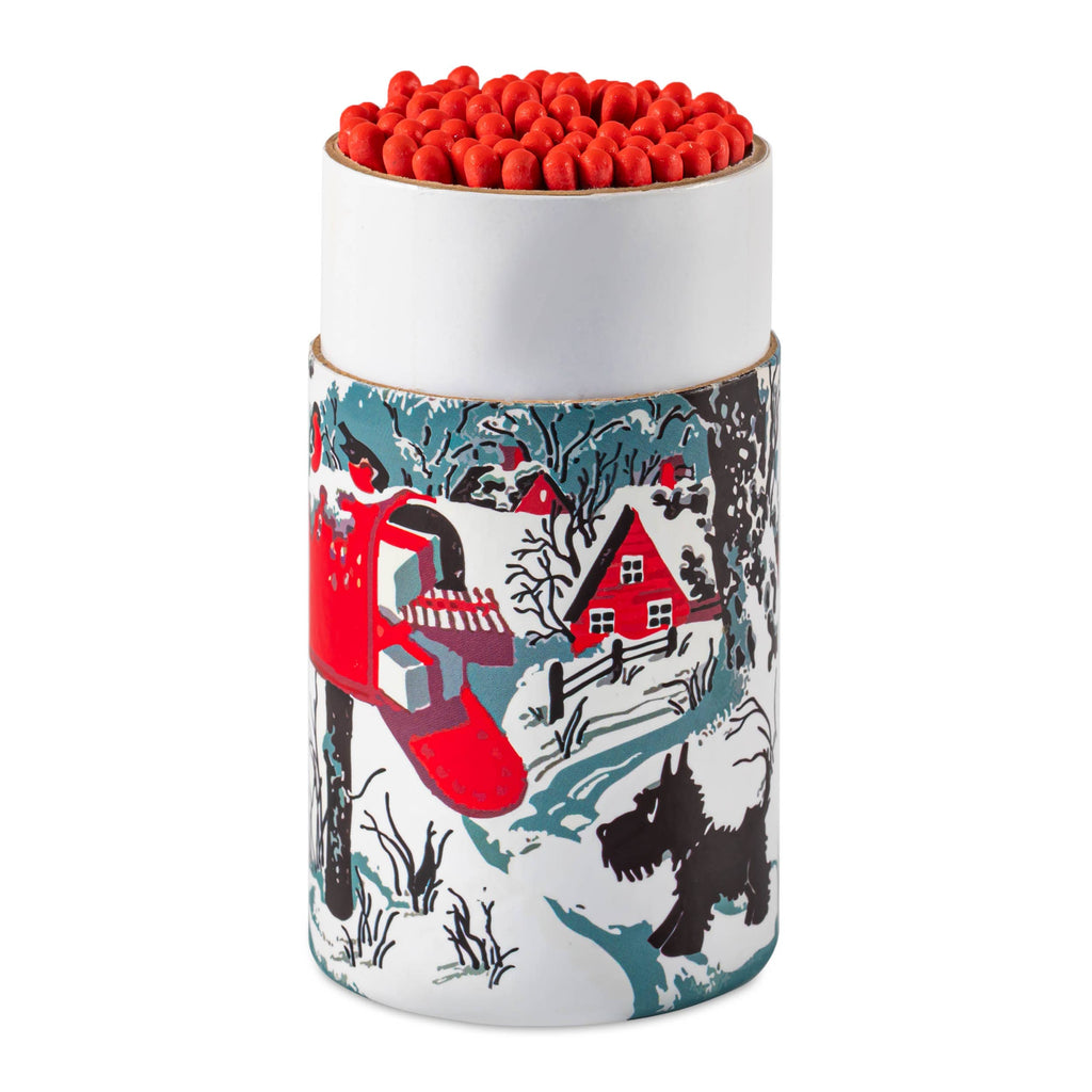 Cylindrical container with red matches, featuring a winter scene design on the side.