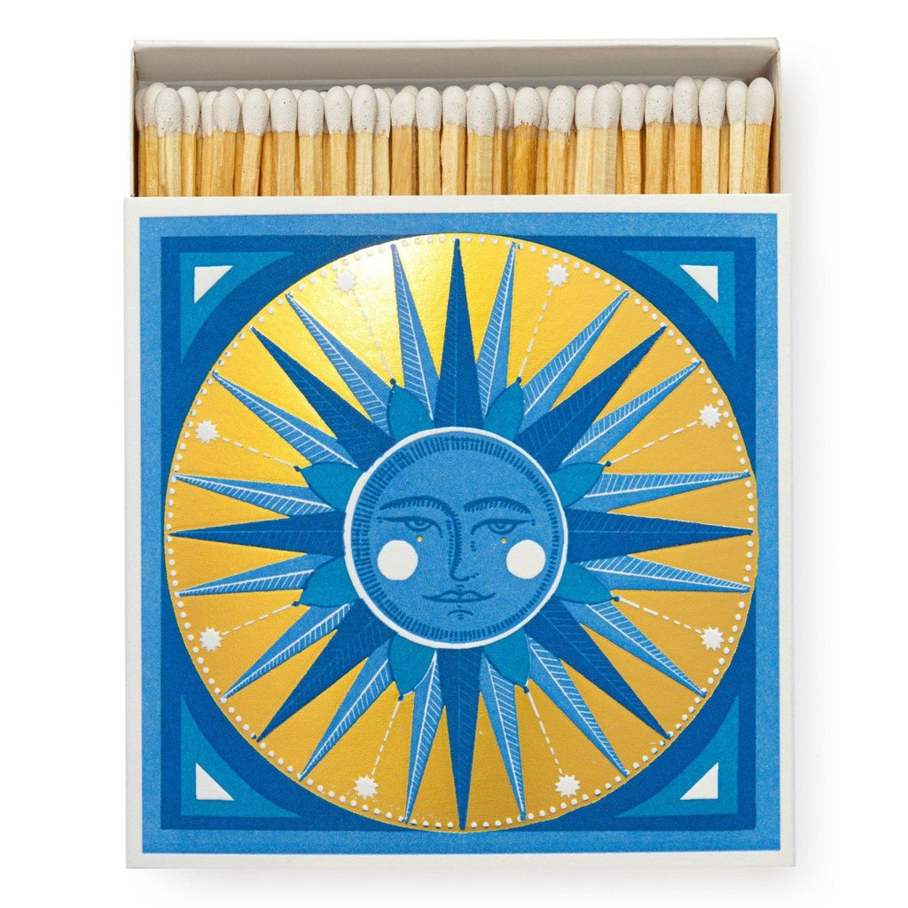 Boxed matches by Archivist Gallery with white match heads, and a golden sun illustration on the box.
