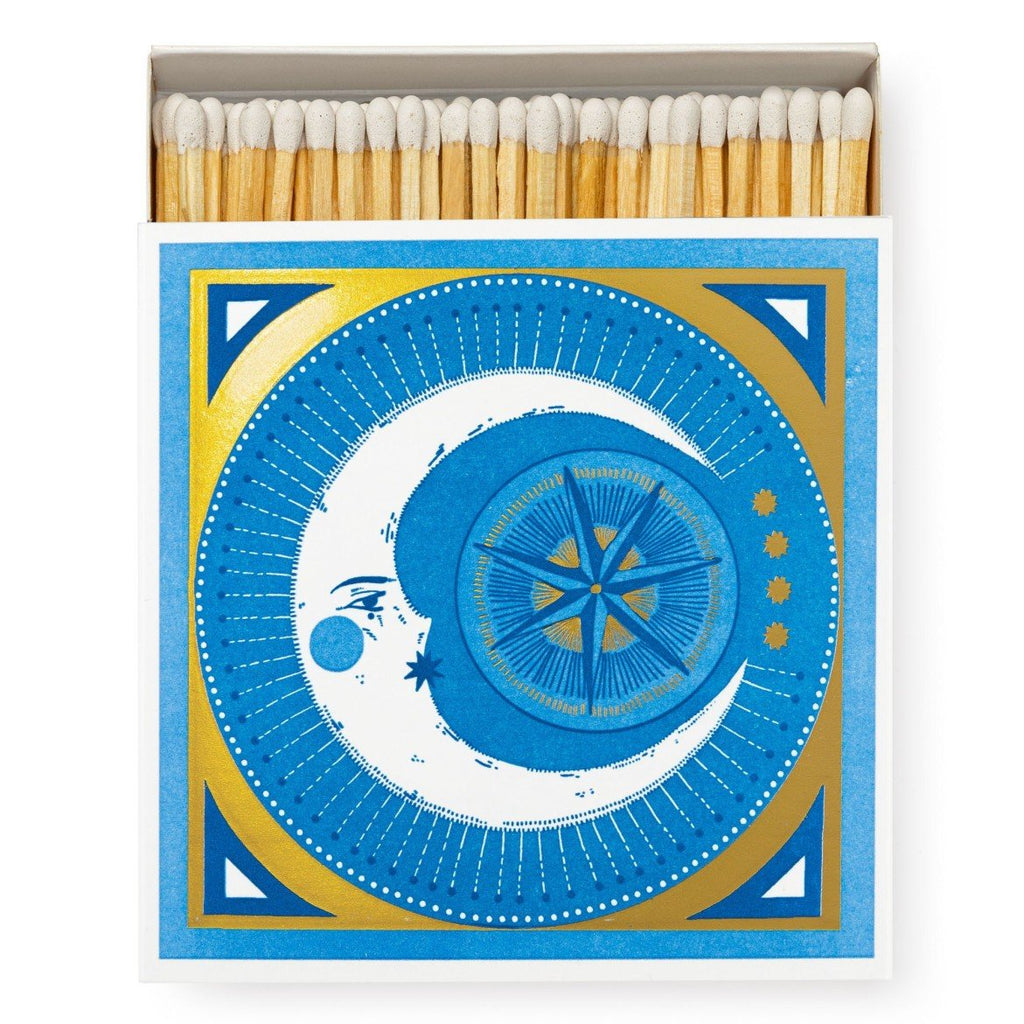 Boxed matches, with white tipped match heads and a golden moon illustration on the cover.