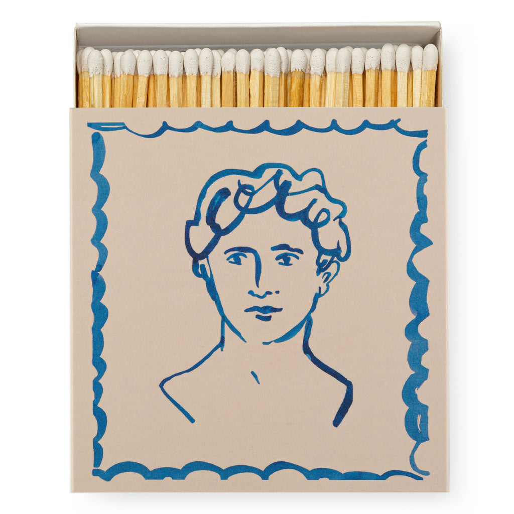Luxury boxed matches by Wanderlust Paper Co, featuring an illustrated portrait of a male figure, painted with a loose style in navy ink.