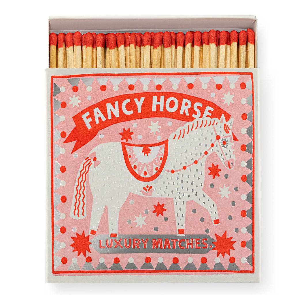 Luxury matchbox by Archivist Gallery, featuring a dancing horse and red, white and silver detailing. Text reads'Fancy Horse'. 