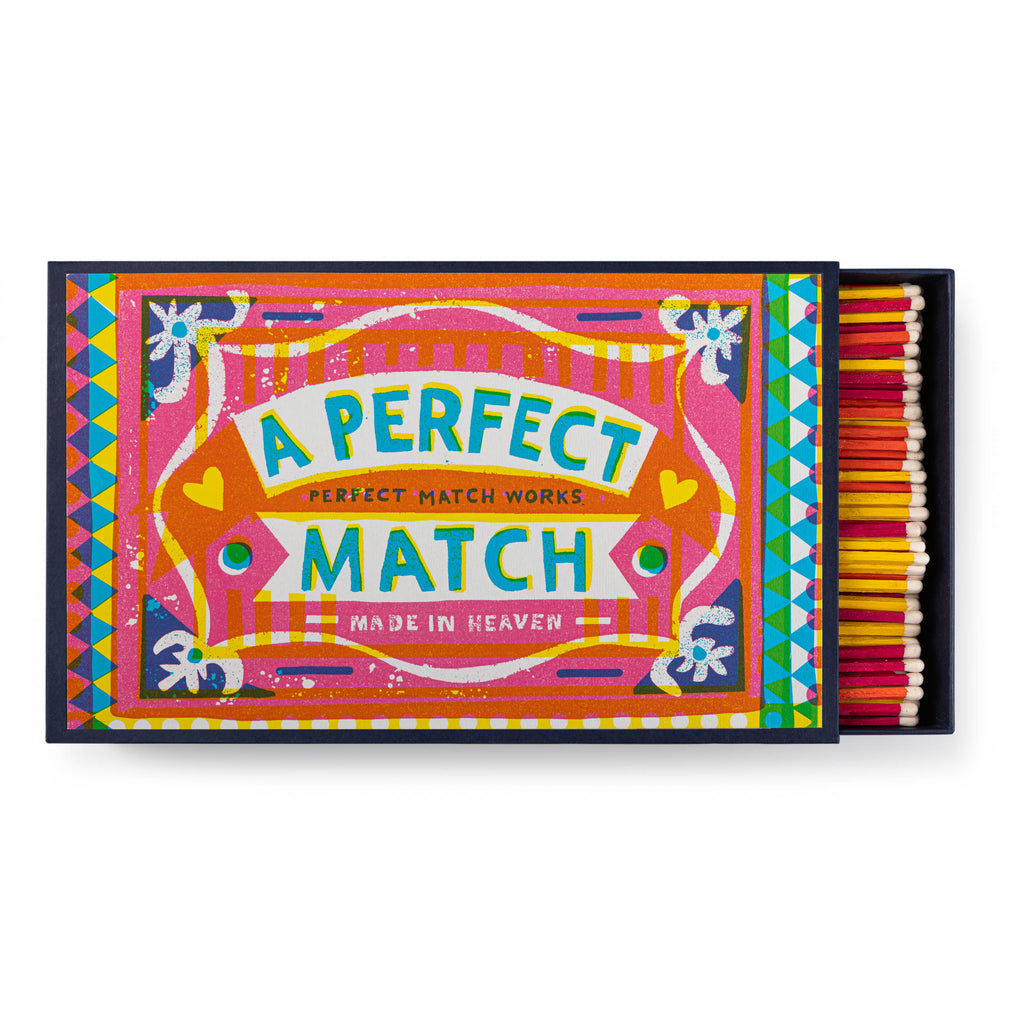 A brightly coloured matchbox, with pink, yellow and orange coloured matches inside. Box reads 'A Perfect Match' 