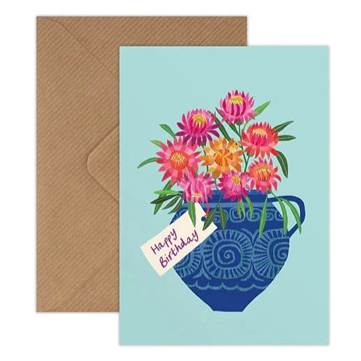Designed by Brie Harrison in Suffolk, and inspired by nature this card features colourful flowers in a blue vase on a pale blue background with the message 'Happy Birthday'
