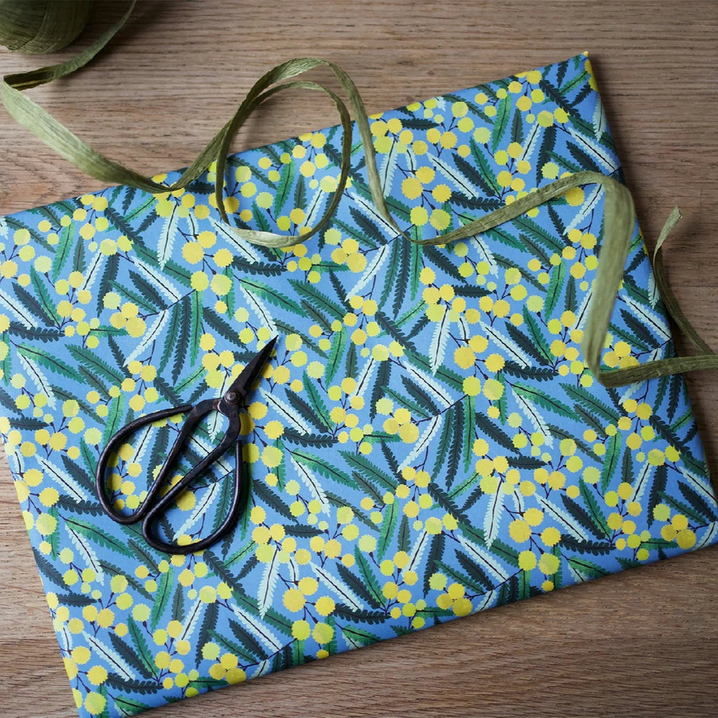 Gift wrapped in blue, yellow, and green floral paper