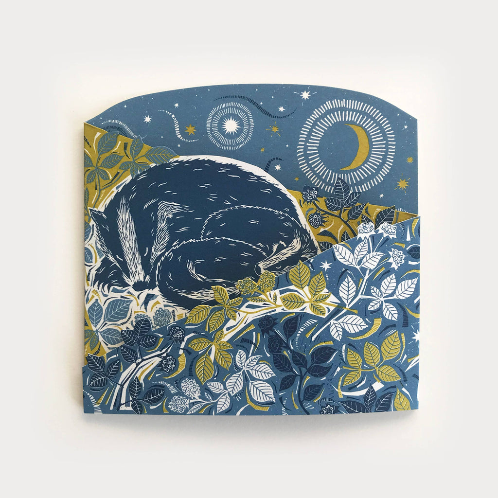 Folded concertina greetings card featuring three sleeping badgers