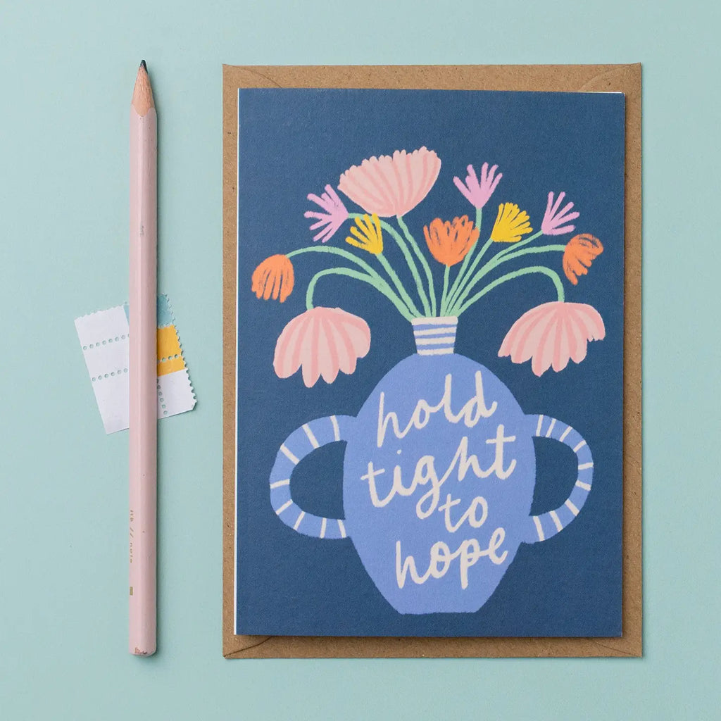 Greeting card with floral design and 'hold tight to hope' text on a blue vase and dark blue background