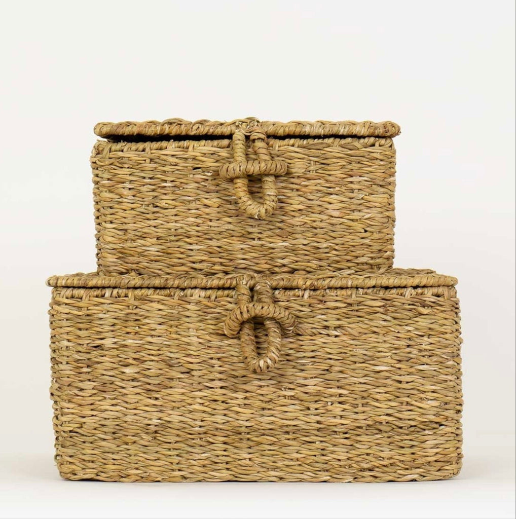 Two woven storage baskets with handles on a white background