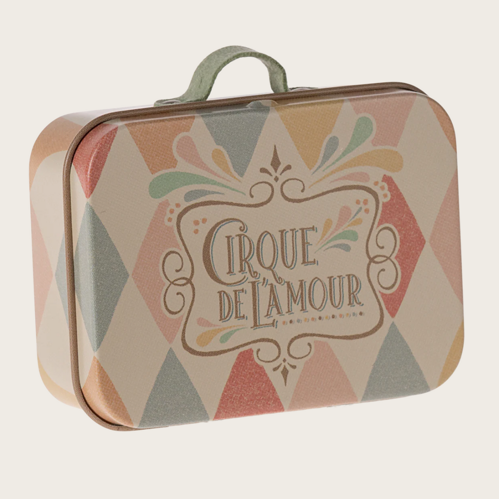 Decorative tin box with 'Cirque de l'Amour' design on a white background