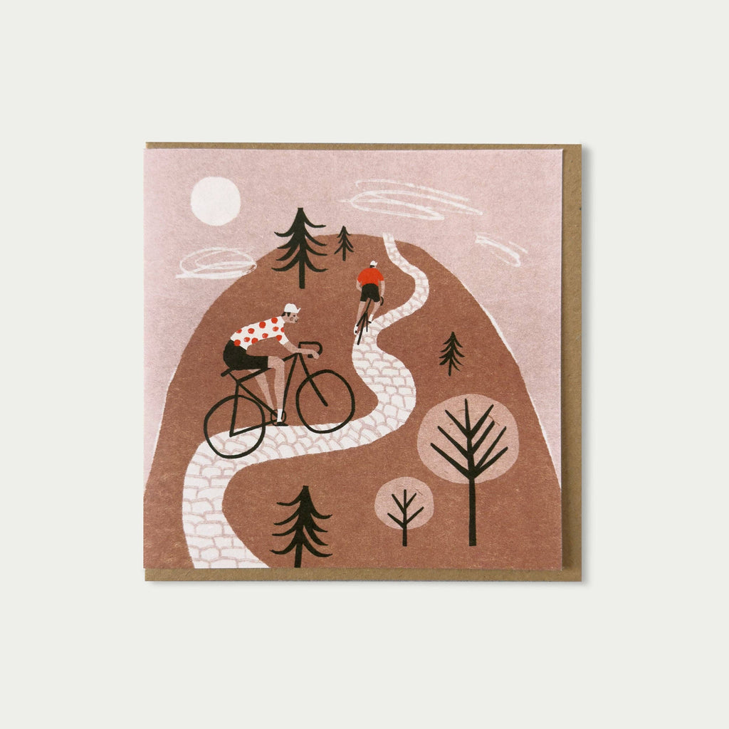 Illustration of two cyclists on a winding road with trees and a moon in the background.