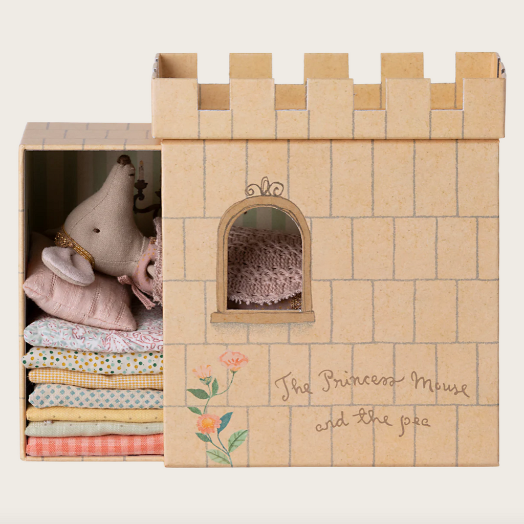 Cardboard castle toy with stuffed animals and fabric inside, branded 'The Princess Mouse and the Pea'.
