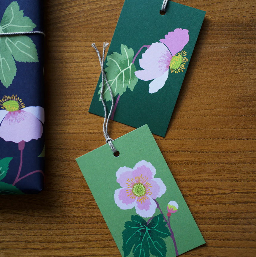 Floral gift tags on a wooden surface
