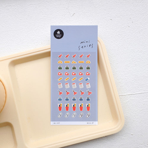 Sheet of colorful stickers on a white tray with a light gray background