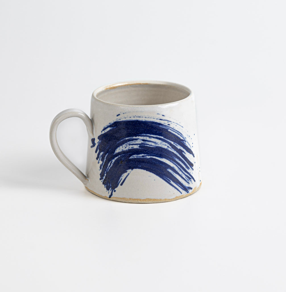Handmade stoneware mug with blue wash painted glaze.