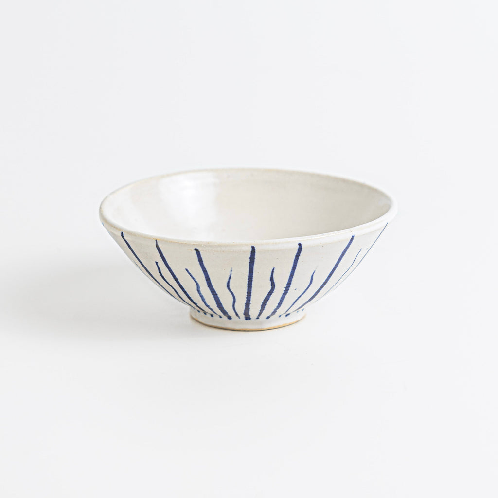 Handmade stoneware dipping bowl with navy blue striped pattern.