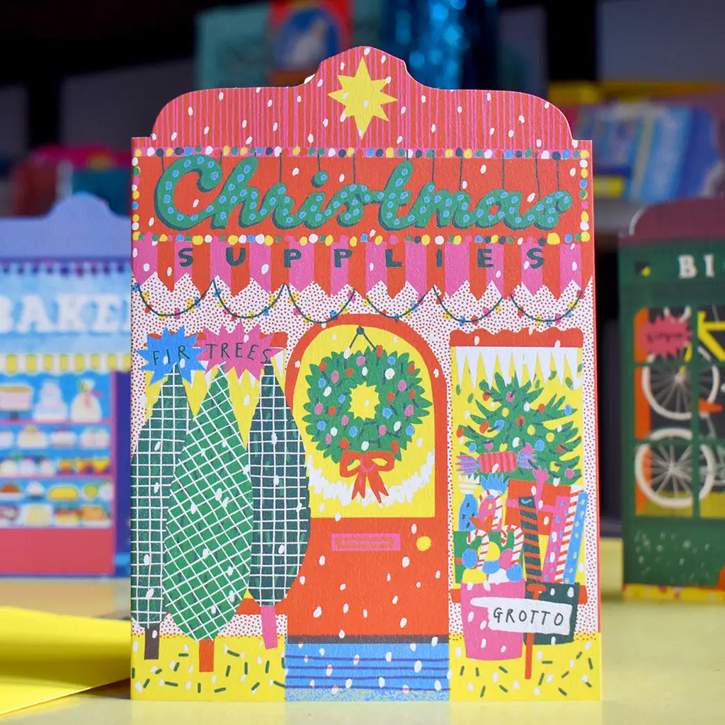 Colourful illustration of a Christmas shopfront with Christmas supplies.
