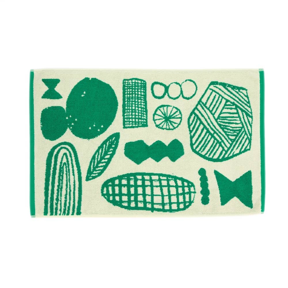 Cream and green bath mat with graphic drawn design