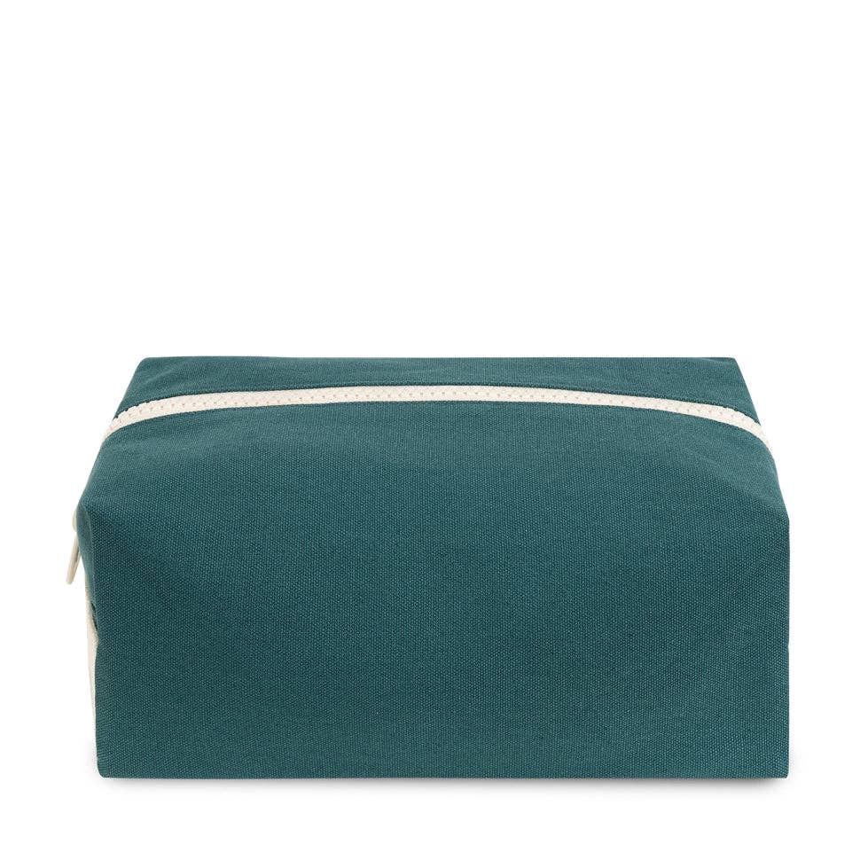 Teal toiletry bag with a white zipper on a white background