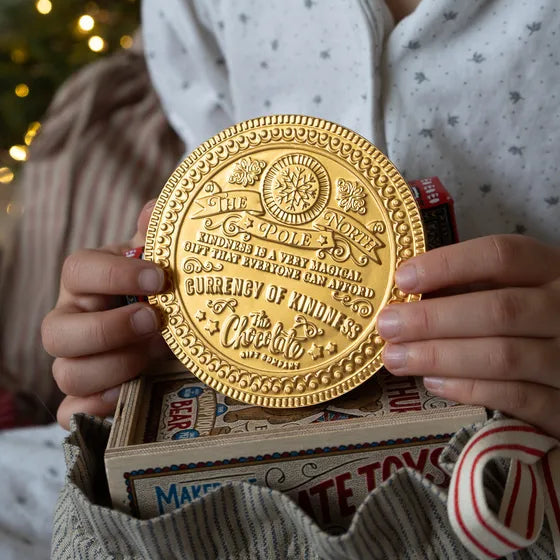 Gold chocolate coin, embossed with a message from the north pole.