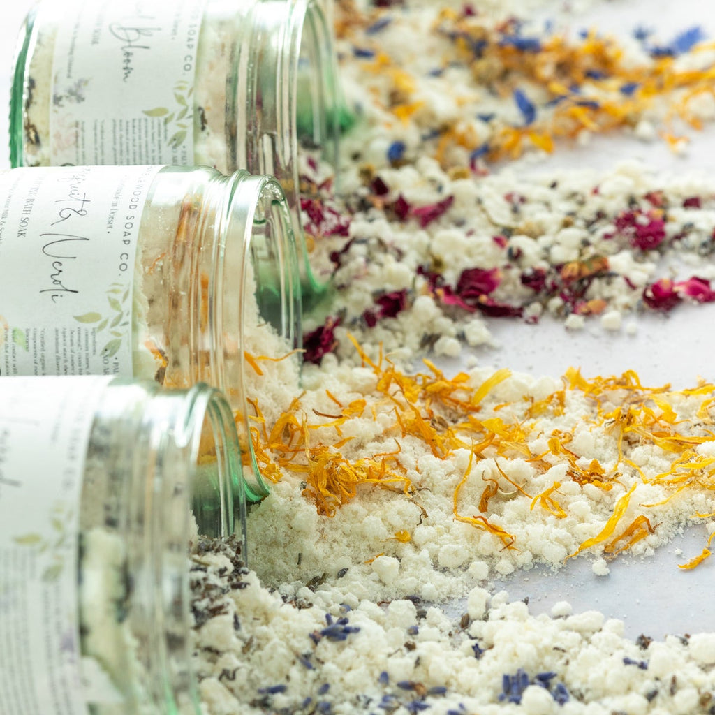 Jars of luxurious bath salts, infused with dried botanicals made by Bramblewood.