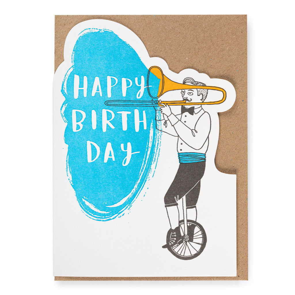 Greetings card by Archivist Gallery, featuring a unicycle riding performer playing the trombone, with a 'Happy Birthday' message.