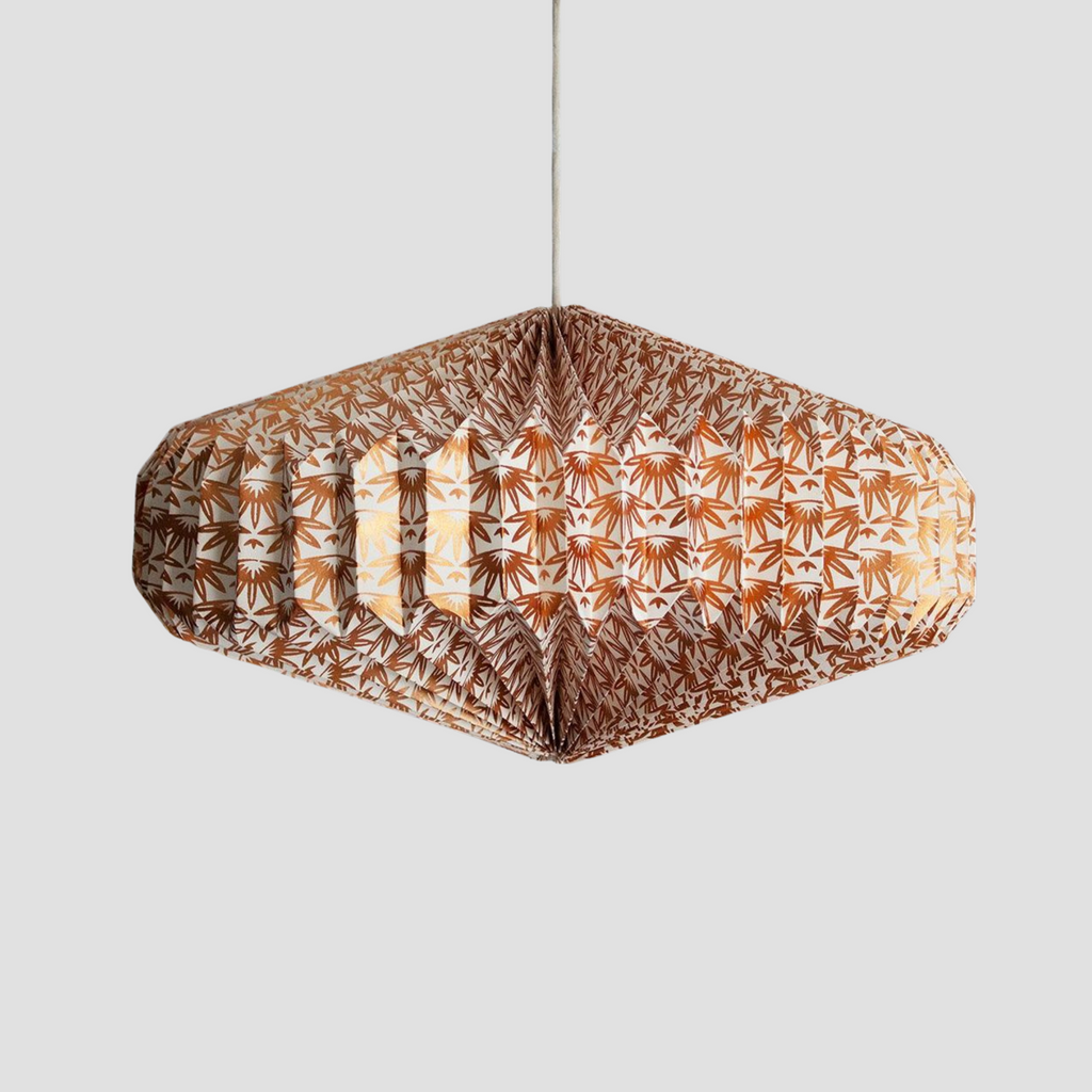 Recycled paper lightshade with bronze palm pattern.