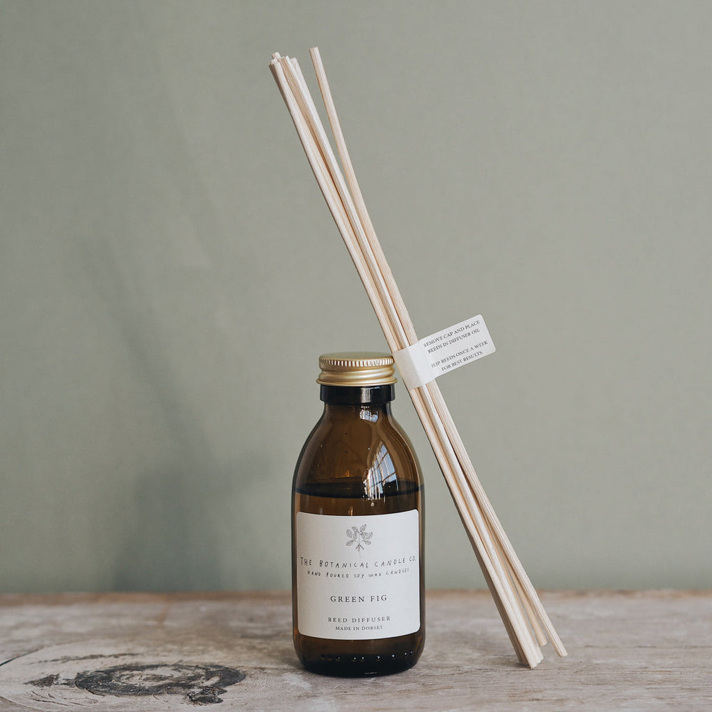 Handmade'Green Fig' Reed Diffuser, with reeds on a wooden table